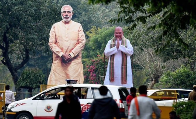 Cut-outs of Narendra Modi and Amit Shah outside party headquarters in Delhi