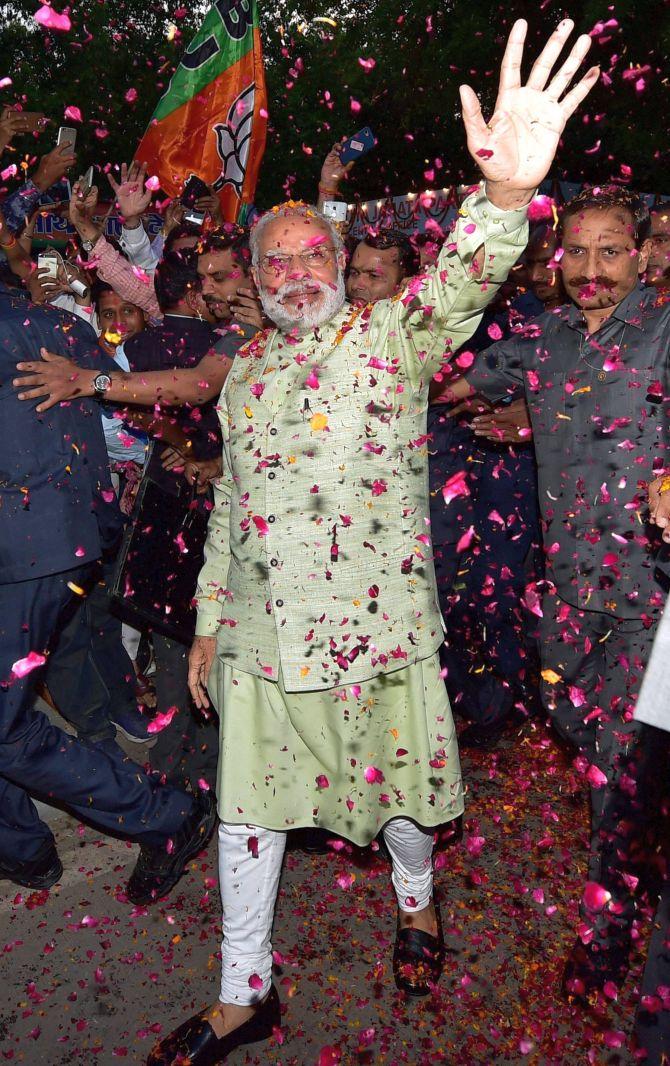 Narendra Modi welcomed with rose petals at the Bharatiya Janata Party headquarters, March 12, 2017. Photograph: Manvender Vashist/PTI Photo