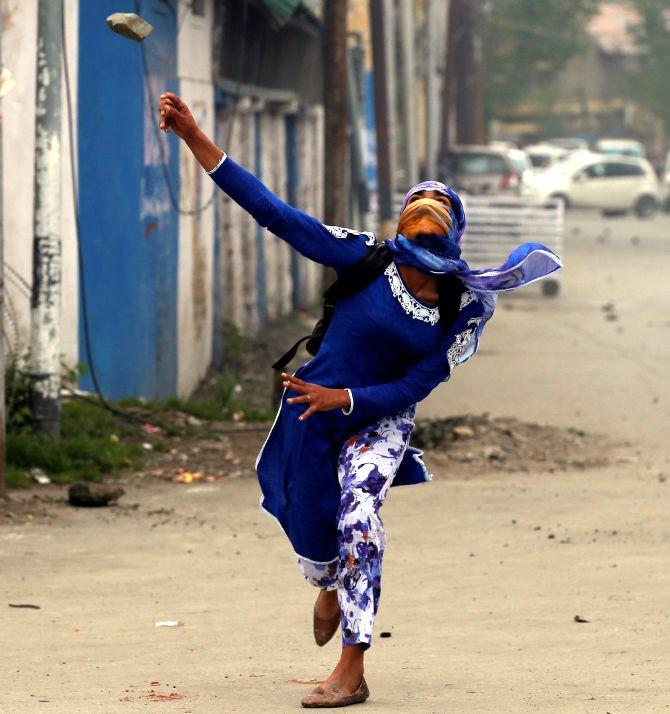 A youth hurls a stone at security forces in the Kashmir valley. Photograph: Danish Ismail/Reuters