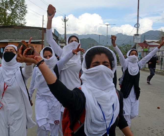 Young Kashmiri women hurl stones at security forces in Srinagar. Photograph: Umar Ganie