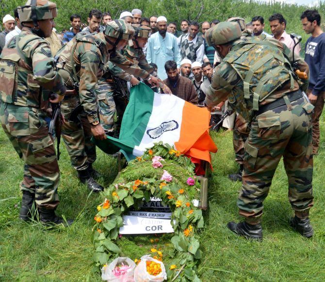 Army personnel pay tribute to slain army officer Lieutenant Ummer Fayyaz during his funeral at his native village Sudsona in Kulgam district. Photograph: PTI Photo