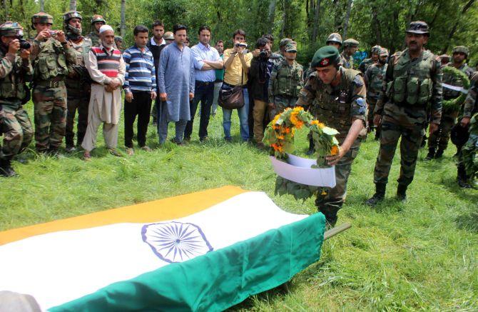 An army officer pays tribute to Lieutenant Ummer Fayaz, who was murdered by terrorists, at his funeral. Photograph: Umar Ganie