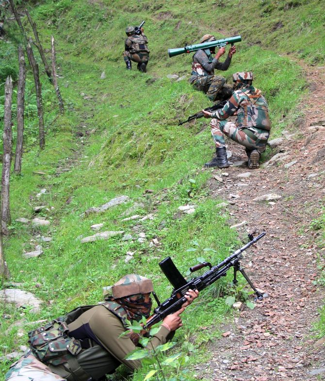 Indian Army soldiers on the look out for terrorists in Nowgam, north Kashmir, May 20, 2017. Three jawans and four terrorists were killed in the encounter. Photograph: Umar Ganie for Rediff.com