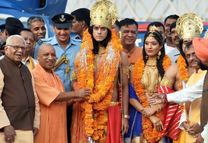 IMAGE: Uttar Pradesh Chief Minister Ajay Singh Bisht and Governor Ram Naik pose with artistes dressed up as Ram, Sita and Lakshman in Ayodhya. Photograph: Nand Kumar/PTI Photo