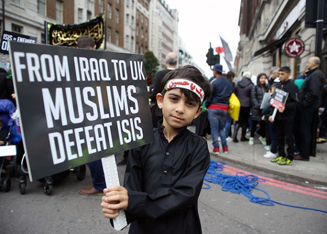 A boy holds a protest banner during an anti-ISIS march in central London, October 1, 2017. Photograph: Tom Jacobs/Reuters