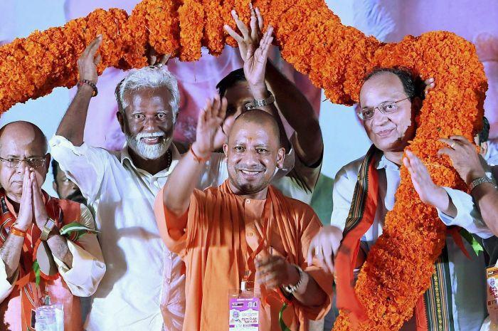 Uttar Pradesh Chief Minister Yogi Adityanath, BJP Kerala President Kummanam Rajasekharan to his right, and other party leaders at a rally in Kannur, Kerala, October 5, 2017. Photograph: PTI Photo