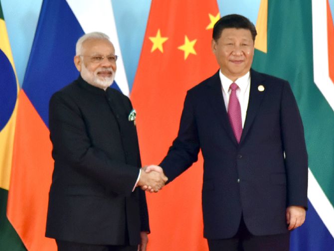 Prime Minister Narendra D Modi is welcomed by Chinese President Xi Jinping at the 9th BRICS summit in Xiamen, September 4, 2017. Photograph: Press Information Bureau