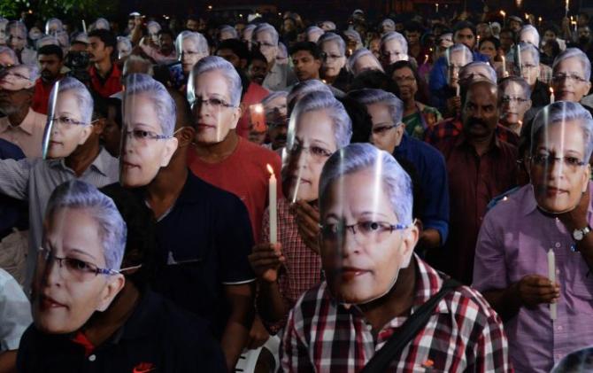 Attendees wear Gauri Lankesh masks at a condolence meeting for the fearless journalist who was murdered outside her home in Bengaluru on September 5, 2017.