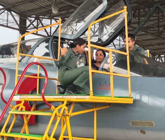 Squadron Leader Vidhu and Flight Lieutenant Kishan explain to Defence Minister Nirmala Sitharaman the working of the cockpit of a Mirage fighter at the Indian Air Force Station in Gwalior. Photograph: Kind courtesy @nsitharaman/Twitter