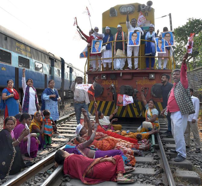Activists stop a train at the Rajendra Nagar Terminal during the Bharat Bandh against the dilution of the Scheduled Caste/Scheduled Tribe Act in Patna. Photograph: PTI Photo