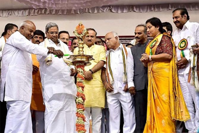 H D Deve Gowda and Karnataka Chief Minister Siddharamaiah light a lamp as Union Minister Ananth Kumar and BJP leader B S Yeddyurappa look on at an event in Bengaluru. Photograph: PTI Photo