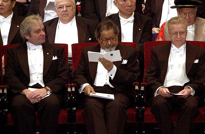 V S Naipaul looks at the programme for the Nobel Prize awards ceremony at the concert hall in Stockholm, December 10, 2001. Photograph: Leif R Janss/Reuters