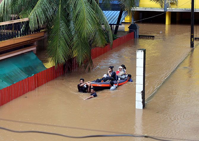 Rescue workers evacuate people from flooded areas after the opening of the Idamalayr, Cheruthoni and Mullaperiyar dam shutters following heavy rains, on the outskirts of Kochi, August 16, 2018. Photograph: Sivaram V/Reuters