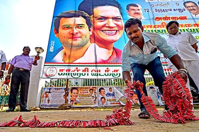A Congress supporter lays down crackers to celebrate the party's performance in the assembly elections of Chhattisgarh, Madhya Pradesh and Rajasthan, whose results most exit polls <a href=https://www.rediff.com/news/report/most-exit-polls-failed-to-get-5-state-polls-right-rajasthan-madhya-pradesh-chhattisgarh-poll/20181212.htm target=new><strong>failed to predict</a></strong>. Photograph: PTI Photo