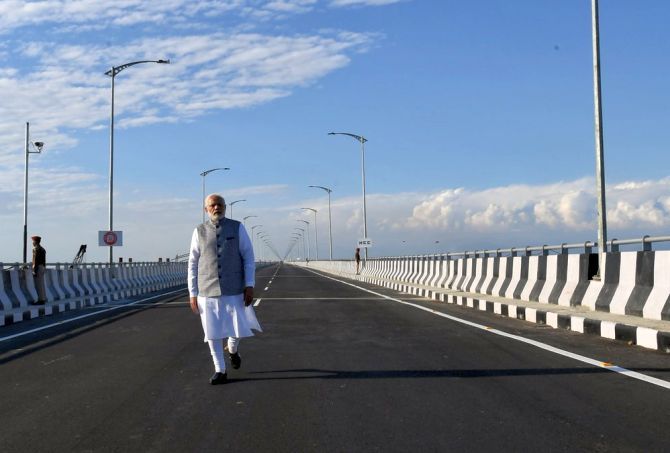 Prime Minister Narendra Damodardas Modi walks on India's longest rail-cum-road bridge over the Brahmaputra river in Bogibeel, Assam, which he inaugurated on December 25, 2018. Photograph: Press Information Bureau