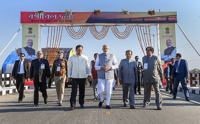 Prime Minister Narendra Damodardas Modi, flanked by Assam Governor Jagdish Mukhi to his left, and Chief Minister Sarbananda Sonowal, on the Bogibeel Bridge, the longest rail-cum-road bridge on the Brahmaputra river, after it was inaugurated, in Dibrugarh, December 25, 2018.