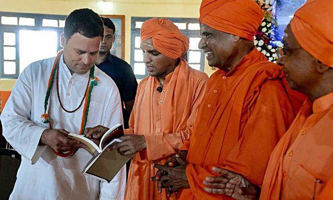 Congress President Rahul Gandhi interacts with sadhus at the Anubhava Mantapa in Basavakalyan, Bidar, Karnataka, February 13, 2018. Photograph: PTI Photo