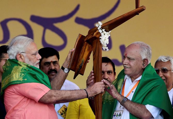 Prime Minister Narendra D Modi, left, on the campiagn trail in Karnataka