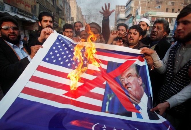 Pakistanis burn a US flag and a picture of US President Donald J Trump at an anti-US rally in Peshawar, January 5, 2018. Photograph: Fayaz Aziz/Reuters
