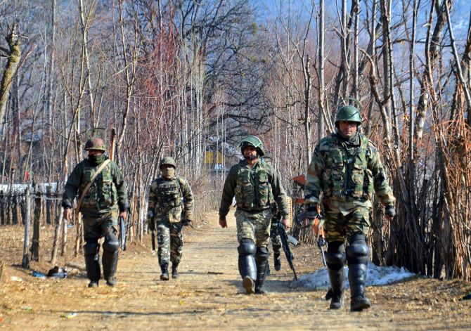 Soldiers move towards a house where terrorists were hiding during an encounter at Kokarnag in Anantnag district, south Kashmir, January 10, 2018. Photograph: PTI
