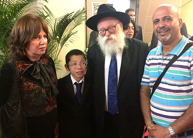 Moshe with his maternal grandparents Yehudit Rosenberg, Rabbi Shimon Rosenberg and Dr Kuresh Zorabi. Dr Zorabi, once a neighbour of the Holtzbergs, also attended the memorial service held for Moshe's parents Rabbi Rivka and Gavriel Holtzberg. Dr Zorabi ran an eye clinic around the corner from Chabad House. His family owns the 24x7 Rex Bakery, exactly opposite Chabad House. The bakery was peppered by terrorist bullets and the staff barely escaped with their lives by hiding in the backrooms. The bullet marks are still evident on the wall of the bakery.  Photograph: Kind courtesy Dr Kuresh Zorabi