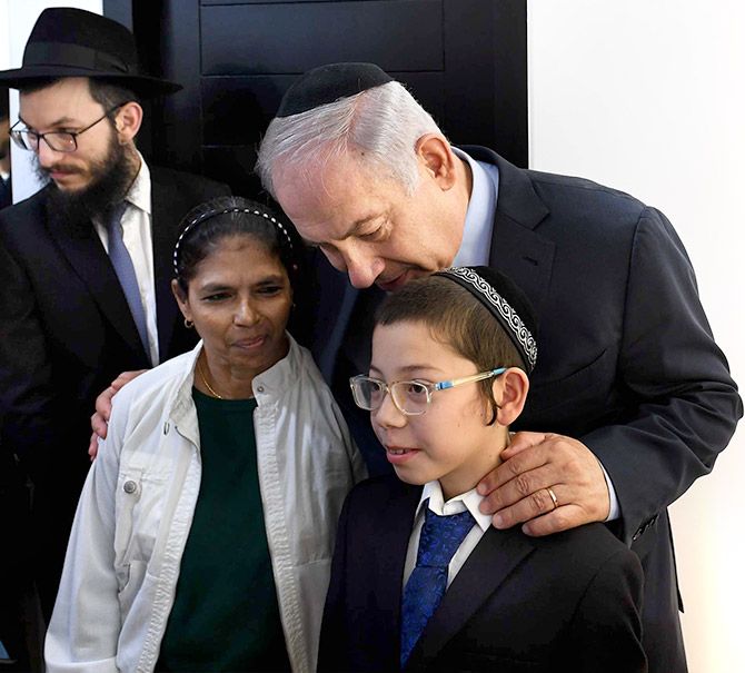 Israeli Prime Minister Benjamin Netanyahu flanked by Moshe Holtzberg and Sandra Samuel, the nanny who saved him from the 26/11 terrorists, at Chabad House, Mumbai, January 18, 2018