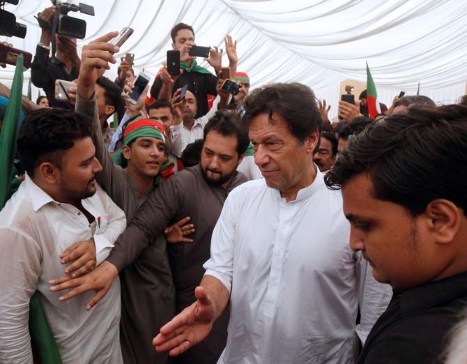 Imran Khan, chairman of the Pakistan Tehreek-e-Insaf political party, asks supporters to clear the way at an election campaign meeting in Karachi,  July 4, 2018. Photograph: Akhtar Soomro/Reuters