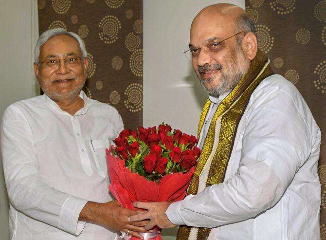 Bharatiya Janata Party President Amit Anilchandra Shah, right, greets Bihar Chief Minister Nitish Kumar at the state guest house in Patna, July 12, 2018. Photograph: PTI Photo