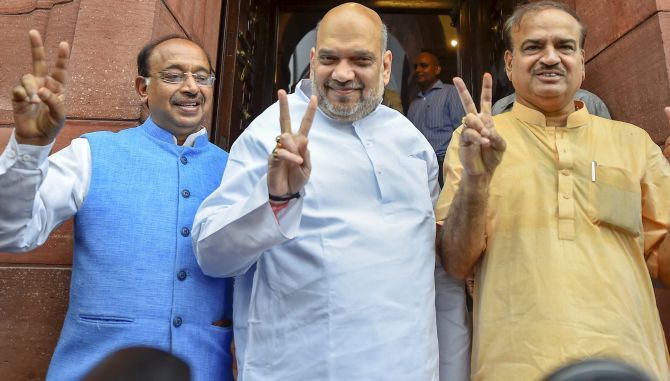 Bharatiya Janata Party national President Amit Anilchandra Shah, centrre, flanked by then parliamentary affairs minister Ananth Kumar, right, and Minister of State for Parliamentary Affairs Vijay Goel flash victory signs ahead of the no-confidence motion in the Lok Sabha, July 20, 2018. Photograph: Kamal Singh/PTI Photo