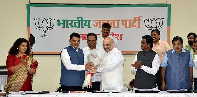 Union Minister Nitin Gadkari, seen right, as Bharatiya Janata Party President Amit Anilchandra Shah felicitates Maharashta Chief Minister Devendra Fadnavis in Mumbai, July 22, 2018. Photograph: Arun Patil