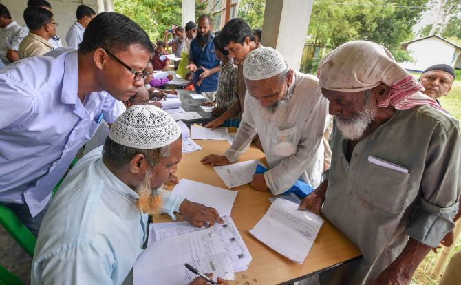 People check their names on the final draft of the National Register of Citizens in Assam