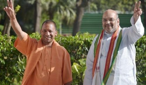 Bharatiya Janata Party President Amit Anilchandra Shah, right, and Uttar Pradesh Chief Minister Ajay Singh Bisht flash victory signs, ironically after the BJP lost the Kairana Lok Sabha by-election in UP in June. Photograph: PTI Photo