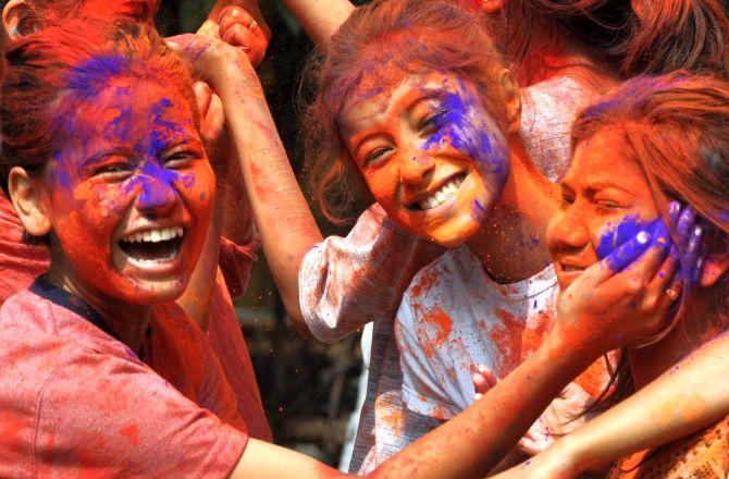 PHOTOS: A riot of colours as India plays Holi - Rediff.com India News