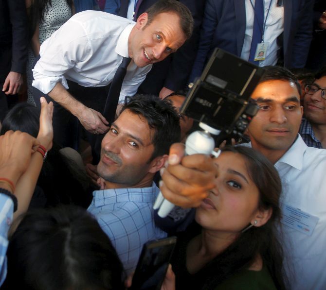 Students take a selfie with Macron, who turned 40 in December, at Delhi's Bikaner House. Photograph: Adnan Abidi/Reuters