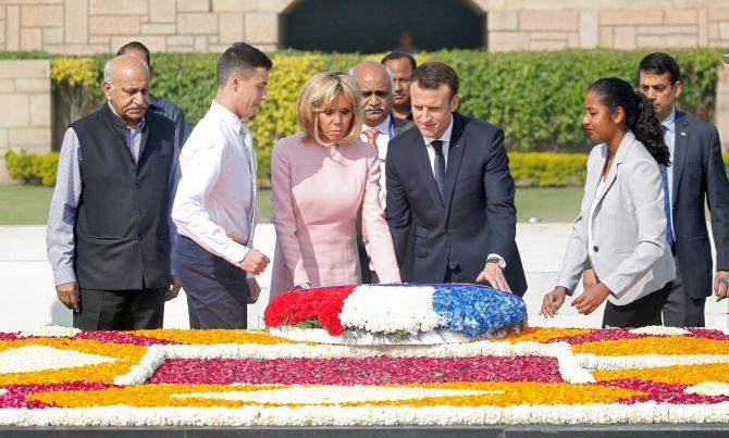 The Macrons pay their respects at the Mahatma Gandhi memorial at Rajghat. Photograph: Altaf Hussain/Reuters