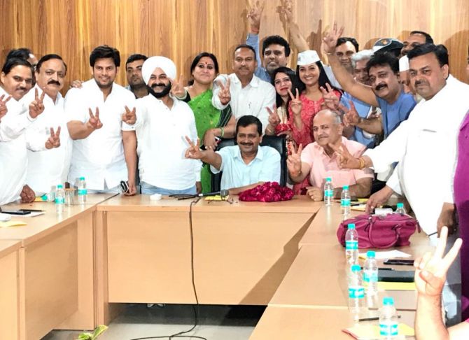 The 20 AAP MLAs, whose disqualification was struck down by the Delhi high court, with Delhi Chief Minister Arvind Kejriwal and Deputy Chief Minister Manish Sisodia after the verdict. Photograph: Kind courtesy @AamAadmiParty/Twitter