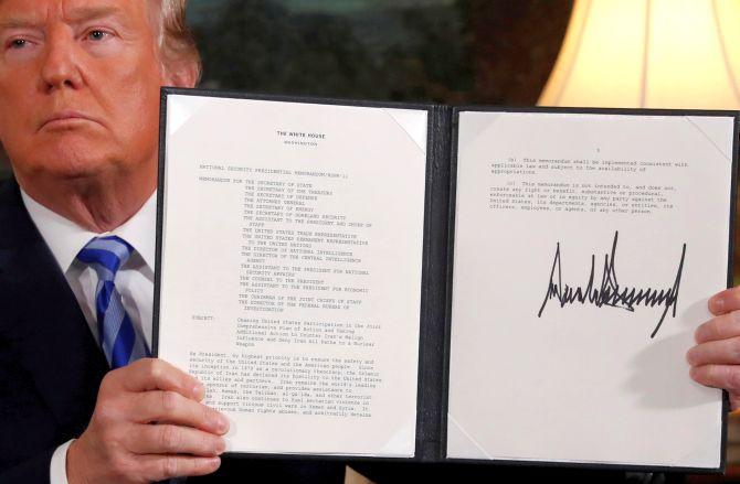 US President Donald Trump holds up a proclamation declaring his intention to withdraw from the JCPOA Iran nuclear agreement after signing it in the Diplomatic Room at the White House in Washington. Photograph: Jonathan Ernst/Reuters