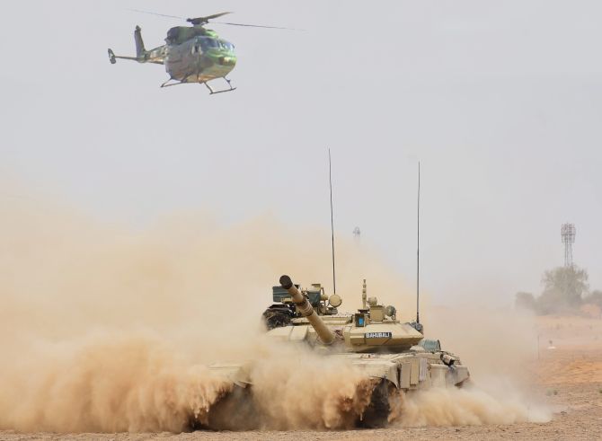 An Indian Army helicopter and tank in coordinated action practice the Air Cavalry concept during the Vijay Prahar exercise at the Mahajan field firing range in Rajasthan, May 2018. Photograph: PTI Photo