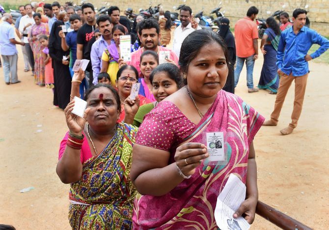 People queue up to cast their ballot for the Karnataka assembly election in Bengaluru, May 12, 2018. Photograph: Shailendra Bhojak/PTI Photo