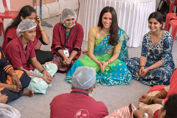 Meghan Markle interacts with the staff during her visit to the Myna Mahila Foundation last year