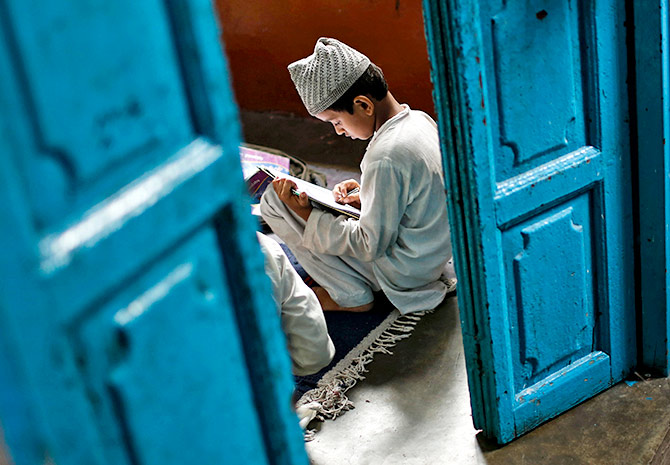A young boy learning at a madrasa