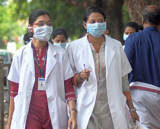 Doctors wear safety masks as a precaution after the outbreak of 'Nipah' virus, at a hospital in Kozhikode
