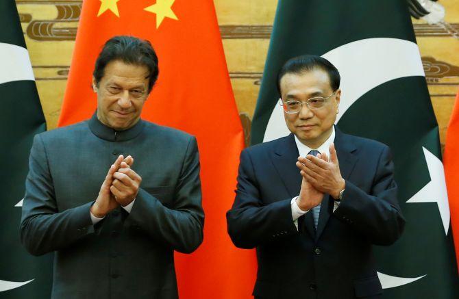 Pakistan Prime Minister Imran Khan, left, and China's Premier Li Keqiang at the Great Hall of the People in Beijing. Photograph: Jason Lee/Pool/Reuters