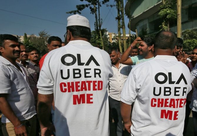 Drivers wear shirts with messages during a protest against Ola and Uber near Ola's office in Mumbai, India October 29, 2018.
