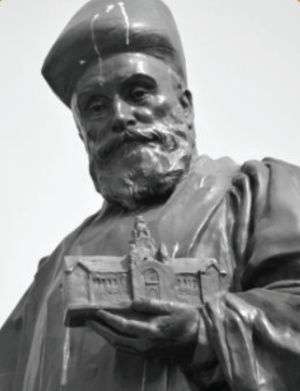 Statue of Jamsetji Tata holding a replica of the Main Building