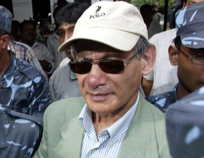 Serial killer Charles Sobhraj emerges from the Kathmandu district court after being sentenced to life in prison for his crimes