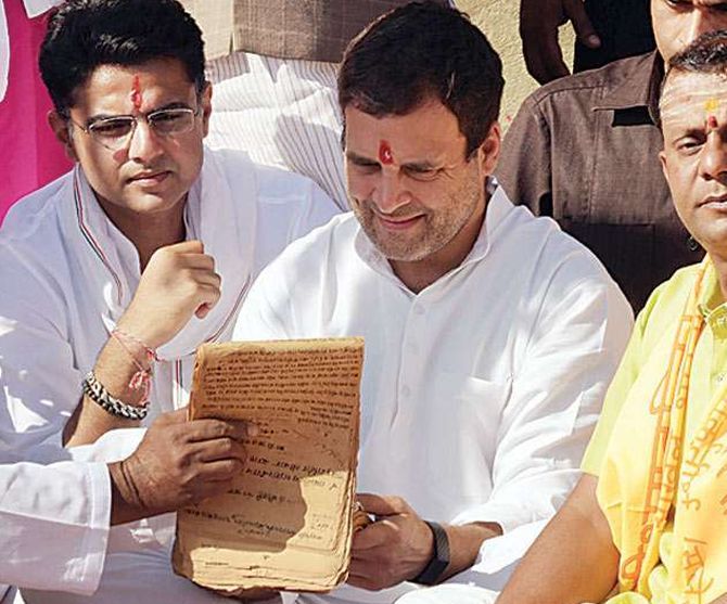 A pandit shows Rahul Gandhi a register containing his family’s lineage at the Pushkar Sarovar, Pushkar, Rajasthan. Photograph: PTI Photo