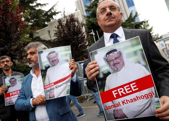 Human rights activists and friends of Saudi journalist Jamal Khashoggi hold his pictures during a protest outside the Saudi consulate in Istanbul. Photograph: Murad Sezer/Reuters