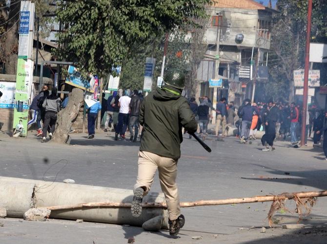 Security forces and Kashmiri youth clash near a house where terrorists had sought shelter in Nowgam, Srinagar, October 24, 2018. Photograph: Umar Ganie for Rediff.com