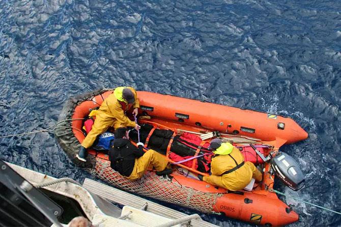 A rescue boat from the French shipping vessel Osiris evacuates Tomy